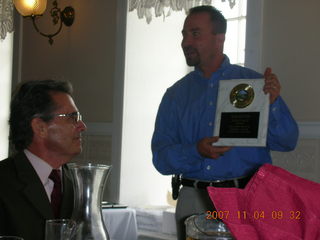 Cheltenham XC banquet - Mike giving Coach 40-year plaque