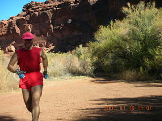 181 6bg. Canyonlands National Park - Lathrop Trail hike - Adam (tripod) running