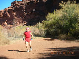 182 6bg. Canyonlands National Park - Lathrop Trail hike - Adam (tripod) running