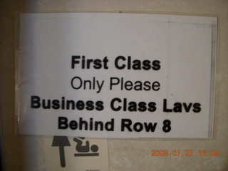 12 6kt. United Airlines first-class seat SFO-PVG sign on bathroom door