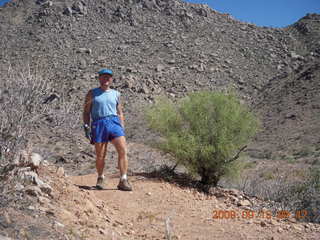 Arches National Park - Adam squeezing through Squeeze Through Arch - Fiery Furnace hike