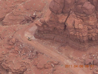 60 7j8. Anticline Overlook - someone driving on dirt road below