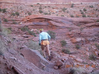 37 7qb. Canyonlands National Park - Lathrop trail hike - Adam hiking - back (tripod)