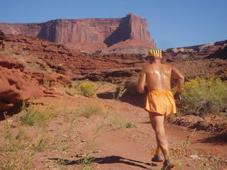 86 7qb. Canyonlands National Park - Lathrop trail hike - Adam running - back (tripod)