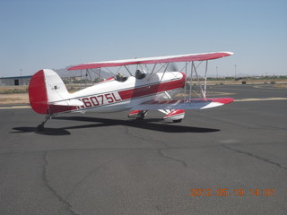 open-cockpit biplane running up at Chandler (CHD)