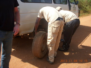 21 8f4. Uganda - drive to chimpanzee park - fixing a flat tire