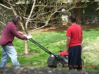 Ivan mowing the lawn with Gaby