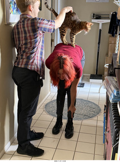 Tyler and Ashley Saenz and cat Pickle on her back
